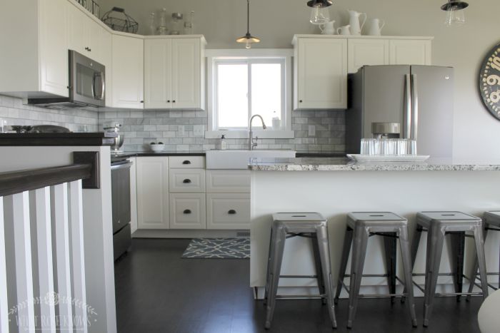 A simple and clean black and white kitchen with rustic and vintage elements. 